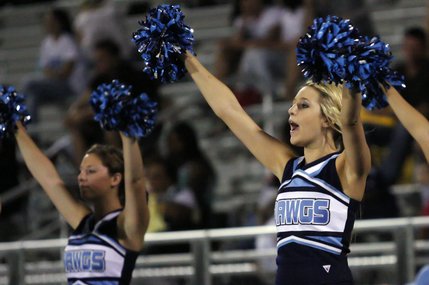Centennial cheerleader Torri Altrache, right, cheers on the Centennial football team during Friday's game at Legacy High School.
