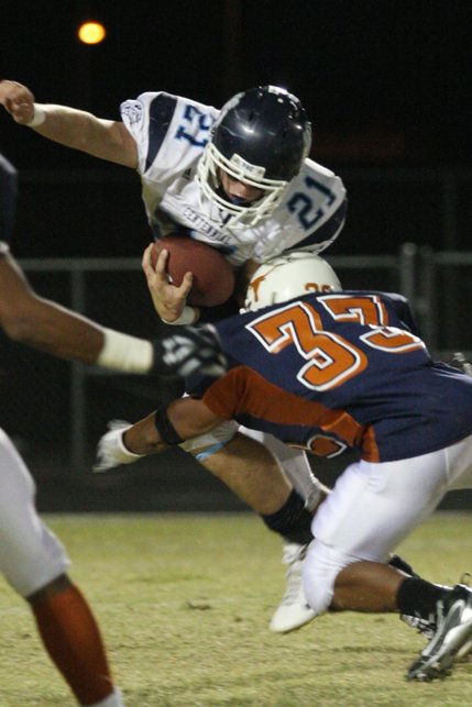 Legacy linebacker Rodney Gilmore takes down Centennial's Matt Holley during Friday's football game at Legacy High School.