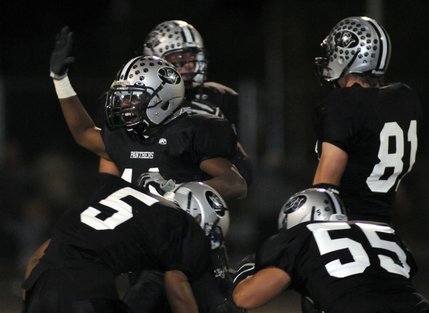 Panther linebacker Tyrone Blake (11) celebrates with his teammates after recovering a fumble during the first half of a game against Cheyenne at Palo Verde High School on Friday.