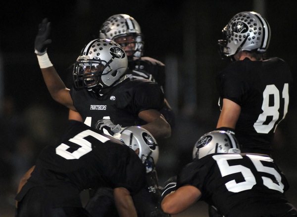 Panther linebacker Tyrone Blake (11) celebrates with his teammates after ...