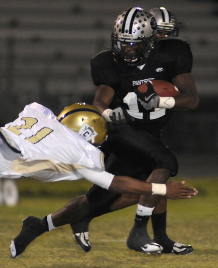 Panther running back Tyrone Blake (11) looks to evade the tackle of Cheyenne's Xavier Johnson (21) during Friday's game at Palo Verde High School.
