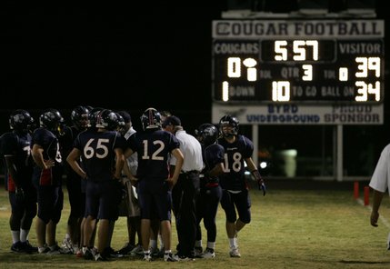 Coronado football coach John Mannion instructs his team during a home game against Basic Friday.