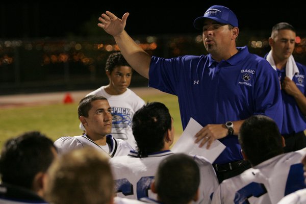 Basic head football coach Jeff Cahill talks to his team ...