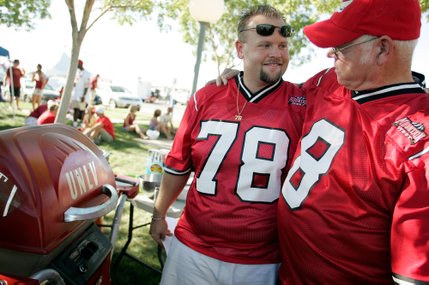 Brian Caudle, left, and his father, Spence Caudle, share a moment in front of the grill while tailgating before the UNLV football game against Iowa State. The Caudles haven't missed a UNLV football home game in 12 years. 