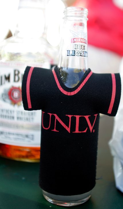 A UNLV beer koozie sits on a tailgate table before the UNLV football game against Iowa State outside Sam Boyd Stadium.