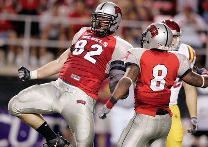 UNLV's Jacob Hales celebrates after a tackle with teammate Daryl Forte during their game against Iowa State at Sam Boyd Stadium.