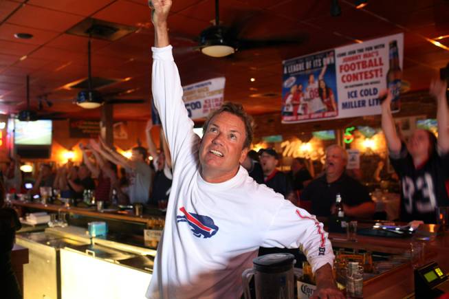 John McGinty, aka Johnny Mac, cheers the Bills at the bar he created in a Henderson strip mall as an oasis for displaced Buffalonians. He says he's raising his own four boys to be Bills fans despite living near Vegas.