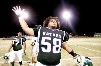 Brigham Tauteoli of Green Valley High School moves his arms like an opening and closing alligator mouth as the crowd chants 