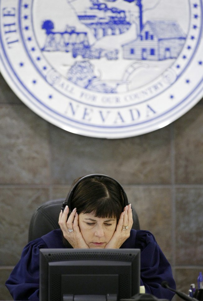 Judge Jackie Glass listens to recordings during O.J. Simpson's trial in Las Vegas, Friday, Sept. 19, 2008. Simpson faces 12 charges, including felony kidnapping, armed robbery and conspiracy. 