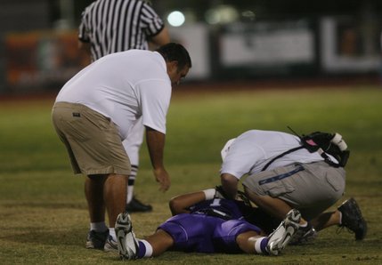Trainers take a look at Silverado linebacker Marcus Mata'u after he was injured during Friday's home game against Liberty.