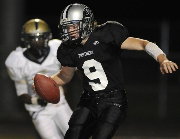 Panthers quarterback Kelly Zurowski (9) scrambles out of the pocket ...