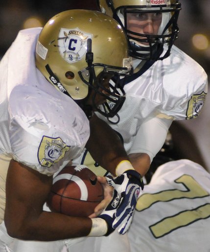 Desert Shield quarterback Chris Spencer hands the ball off to fullback Ronnie Green during the first half of a game against the Panthers at Palo Verde High School on September 19.