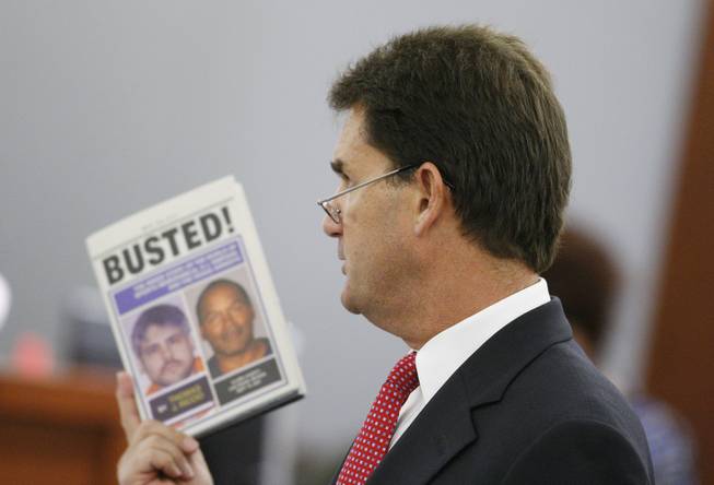 O.J. Simpson's attorney Yale Galanter holds a book written by witness Thomas Riccio in court during Simpson's trial in Las Vegas, Monday, Sept. 22, 2008. Simpson faces 12 charges, including felony kidnapping, armed robbery and conspiracy. 
