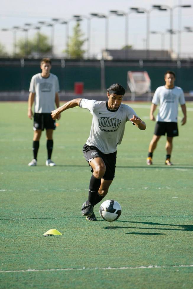 Sophomore UNLV men's soccer player Richard Abrego, 19, drives the soccer ball down field during practice.