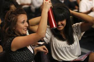 Wanting to look their best on TV, Las Vegas Academy's Anastasia Jerbic, 17, sprays her friend Crystal Soto's hair before the taping of a Teen Town Hall Meeting on Tuesday.