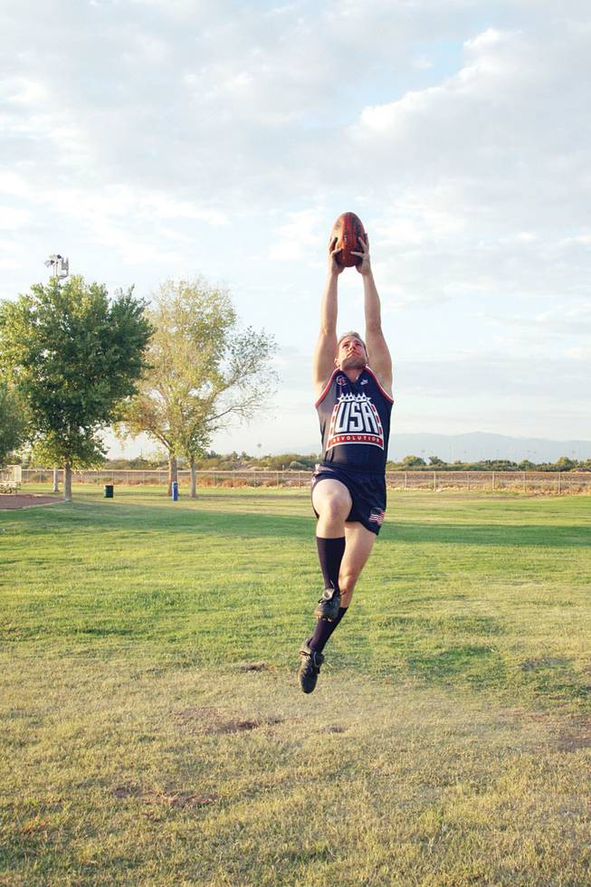 Marty Curry makes a high catch. Curry recently returned from Australia, where he competed for Team USA in the International Cup of Aussie football.