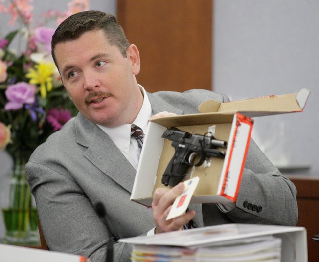 Las Vegas Metropolitan Police detective Andy Caldwell displays a handgun while testifying during the O.J. Simpson trial at the Clark County Regional Justice Center Friday, Sept. 26, 2008, in Las Vegas. 