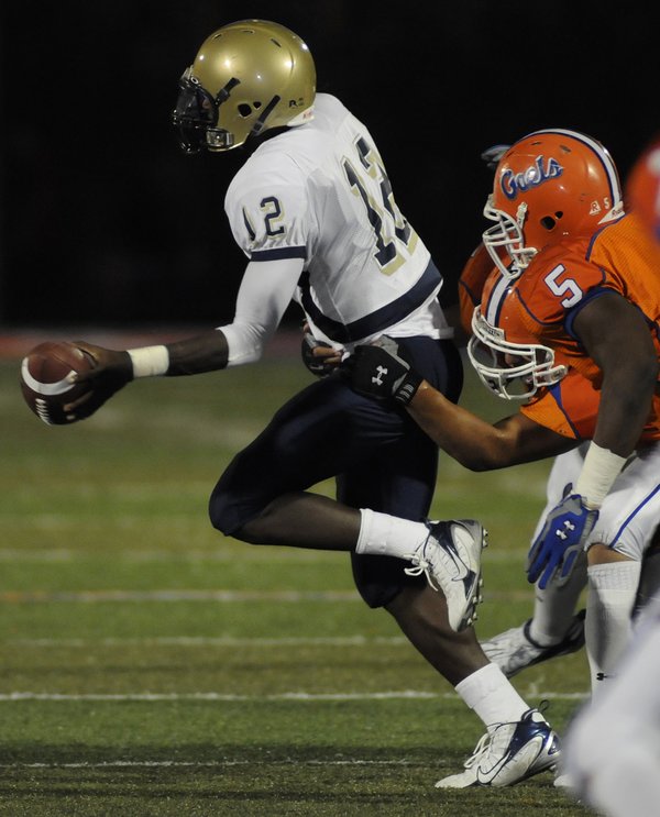 Grizzlies quarterback Anton Stallworth (12) is pressured by the Gaels ...