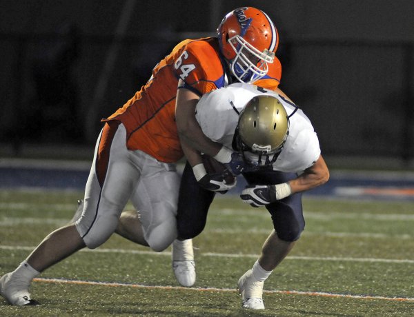 Spring Valley punt returner Larry Calvert (21) is taken down ...