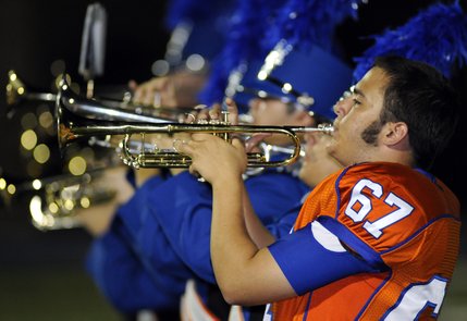 Gaels lineman Brian Glasgow performs with the Bishop Gorman marching band during halftime of Friday's game against Spring Valley at Fertitta Field.