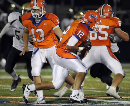 Bishop Gorman fullback Matt Malone (12) gets the handoff from quarterback Chase Cresto (13) late in Friday's game against Spring Valley.