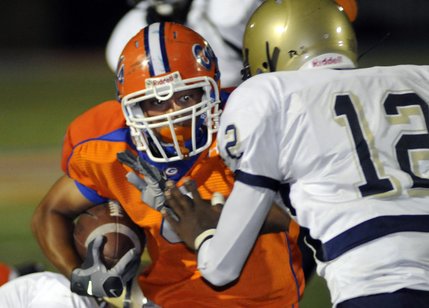 Gaels running back Kawika Antolin (4) eyes approaching tackler Anton Stallworth (12) during a carry in the fourth quarter of Friday's game.