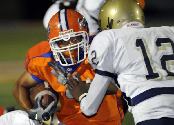 Gaels running back Kawika Antolin (4) eyes approaching tackler Anton ...