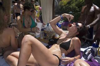 A UCLA law student, Carrie Richeu, nibbles strawberries poolside with friends during a Rehab in late June.