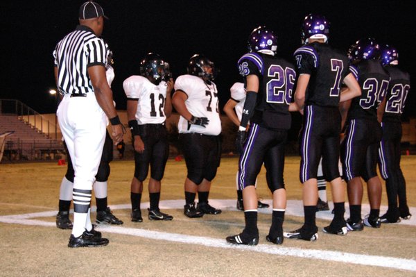 Durango and Clark captains meet for the coin toss at ...