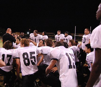 Clark head coach Don Willis talks to his team after earning the first win of the season Friday night at Durango High School. 