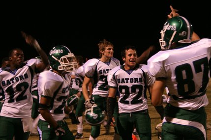 The Green Valley Gators celebrate the third quarter touchdown that put them ahead of the Cougars, 18-8.