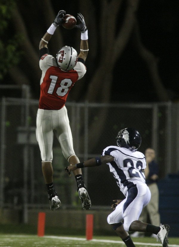 UNLV's Phillip Payne makes a catch over UNR's Joe Easter ...