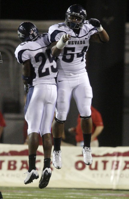 UNR's Mo Harvey, left, and Jerome Johnson celebrate after Harvey intercepted a pass during UNLV's game against the Wolf Pack at Sam Boyd Stadium.