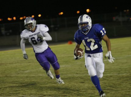 Basic wide receiver Justin Burdno (12) runs the ball during Friday's home game against Silverado.