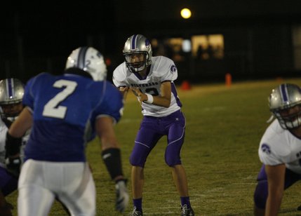Silverado quarterback Kyle Simons (12) makes a call during Friday's game at Basic.
