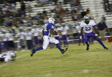Basic running back Charles Phillips (31) breaks away from a tackle during Friday's home game against Silverado.