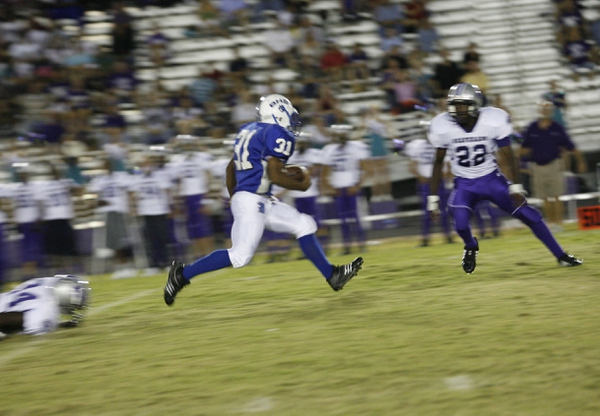 Basic running back Charles Phillips (31) breaks away from a ...