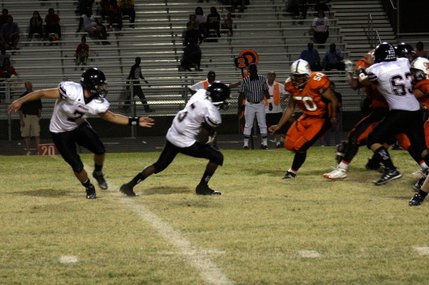 Las Vegas quarterback Emir Lopez passes the ball to Reggie Bullock during Friday's game at Chaparral.