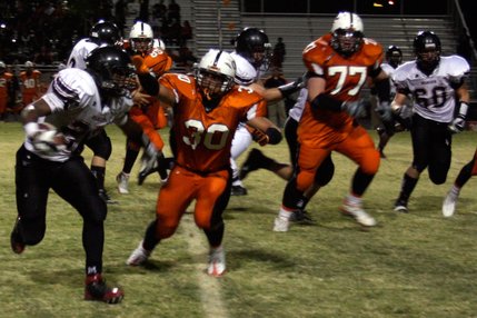 Las Vegas receiver Nico Villarama (27) tries to pass Chaparral defensive end Dominic Morales (30) during Friday night's game.
