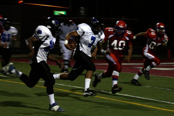 Desert Pines quarterback Dalton Leilua runs the ball for a ...