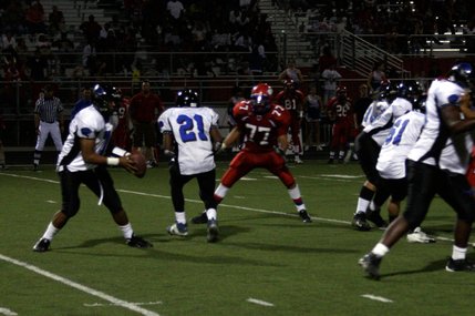 Desert Pines quarterback Dalton Leilua looks for a receiver during Friday's game at Valley.
