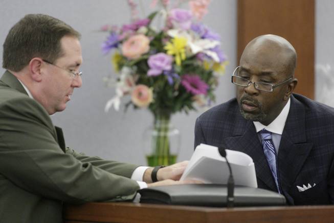 Clark County District Attorney David Roger, left, questions witness Michael McClinton during O.J. Simpson's trial at the Clark County Regional Justice Center Friday, Sept. 26, 2008, in Las Vegas. Simpson faces 12 charges, including felony kidnapping, armed robbery and conspiracy.