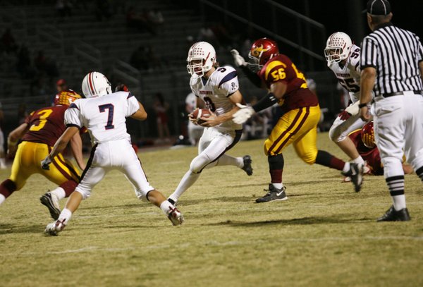 Liberty quarterback Robert Gilliland (9) looks to evade a tackle ...