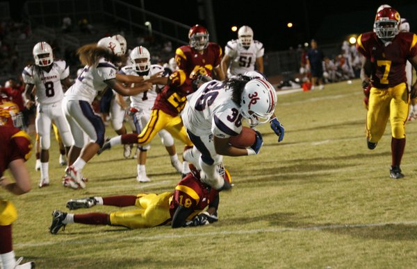 Liberty running back Jordan Kapeli (36) dives into the endzone ...