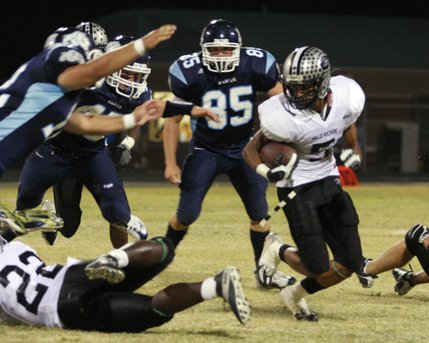 Palo Verde running back Torin Harris runs past the Centennial defense during Friday's game at Centennial High School.