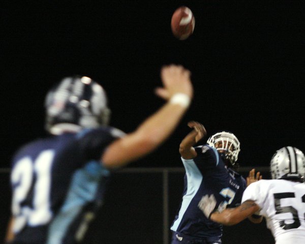 Centennial quarterback Chris Henderson attempts a pass to teammate Brandon ...