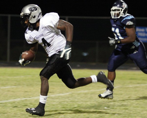 Palo Verde running back Sidney Hodge runs past the Centennial ...