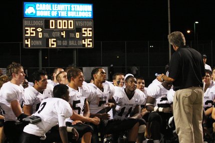 Palo Verde coach Darwin Rost, who won his 100th game Friday night, talks with his players after the game at Centennial High School.