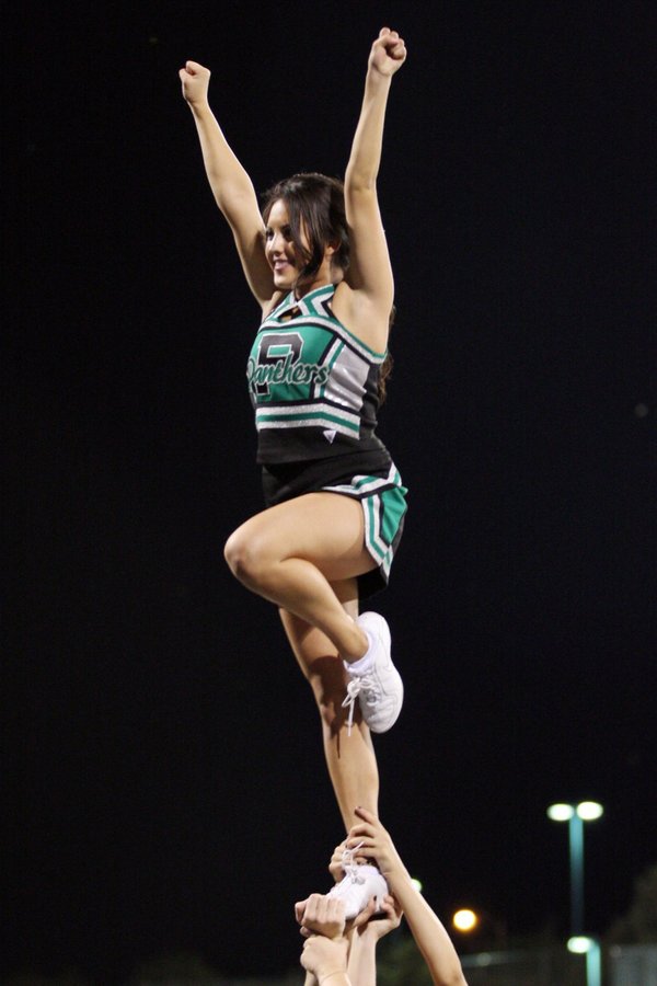 Palo Verde cheerleader Julia Bunanto stands on top of the ...