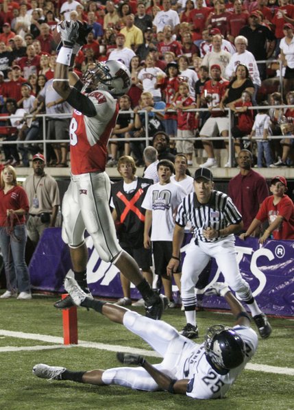 UNLV wide receiver Phillip Payne pulls in a touchdown pass over UNR defensive back Mo Harvey during the first half.